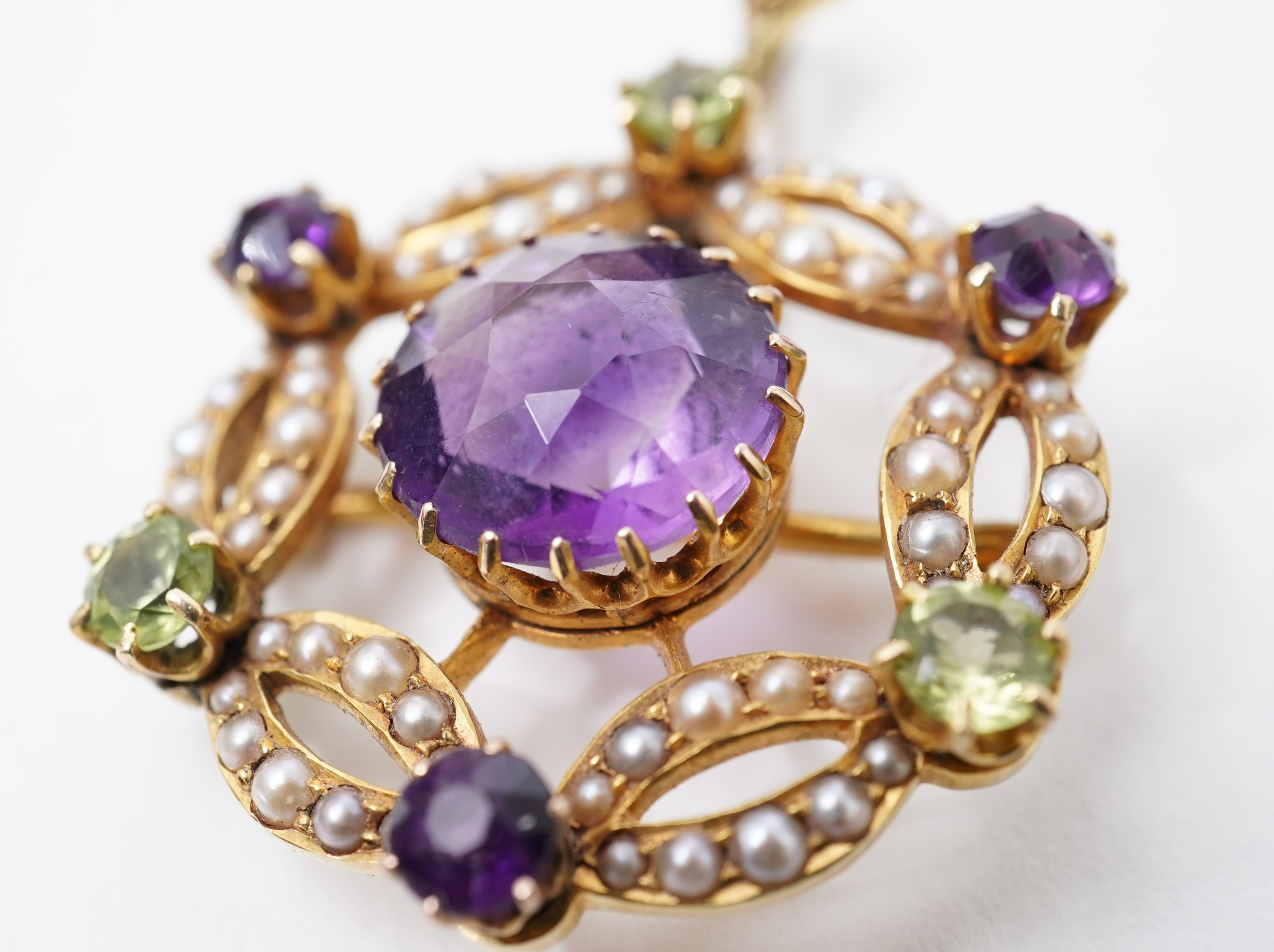 An Edwardian amethyst, chrysoberyl and seed pearl pendant/brooch, early 20th century